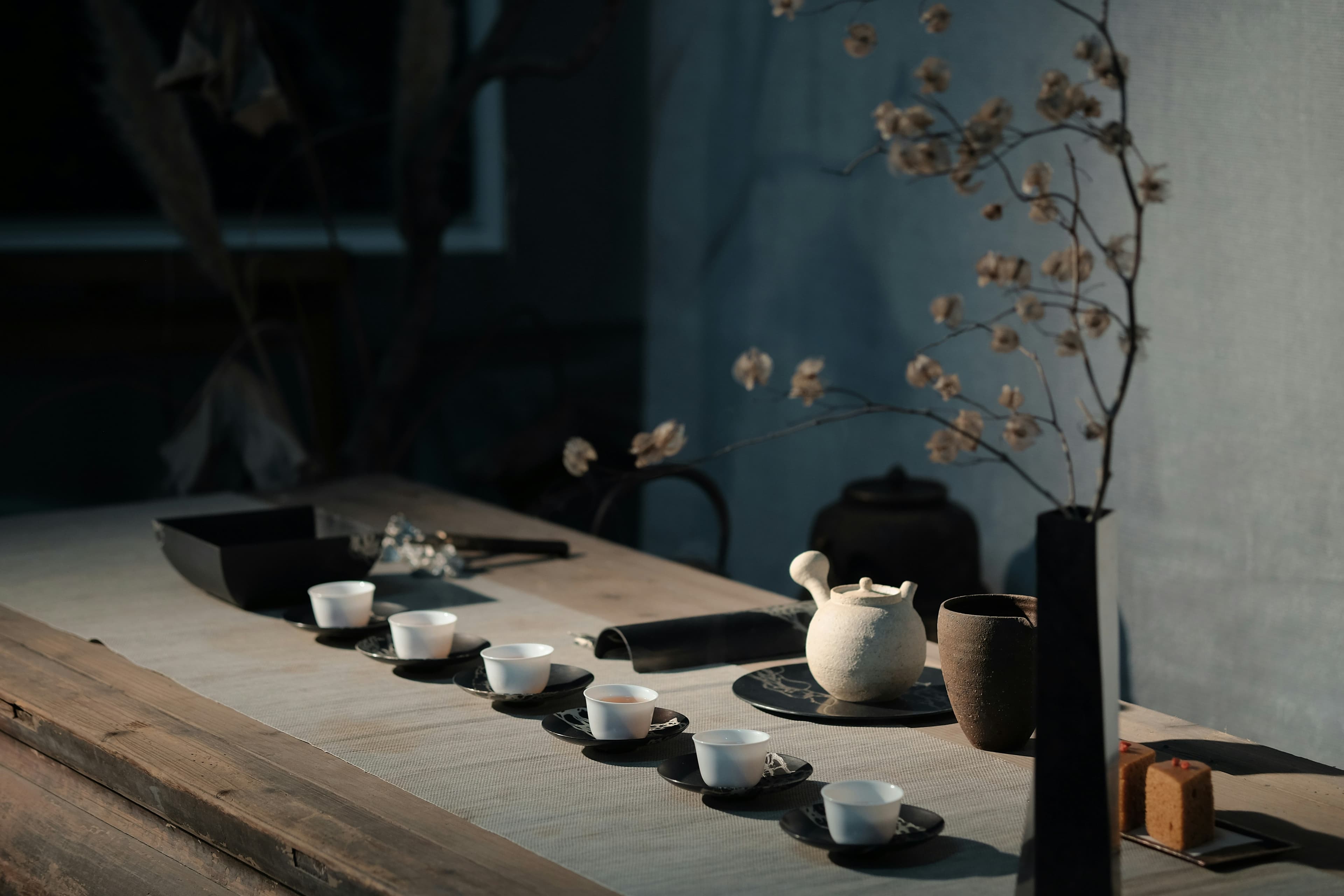 Japanese tea ceremony setup with teapot and cups on wooden table