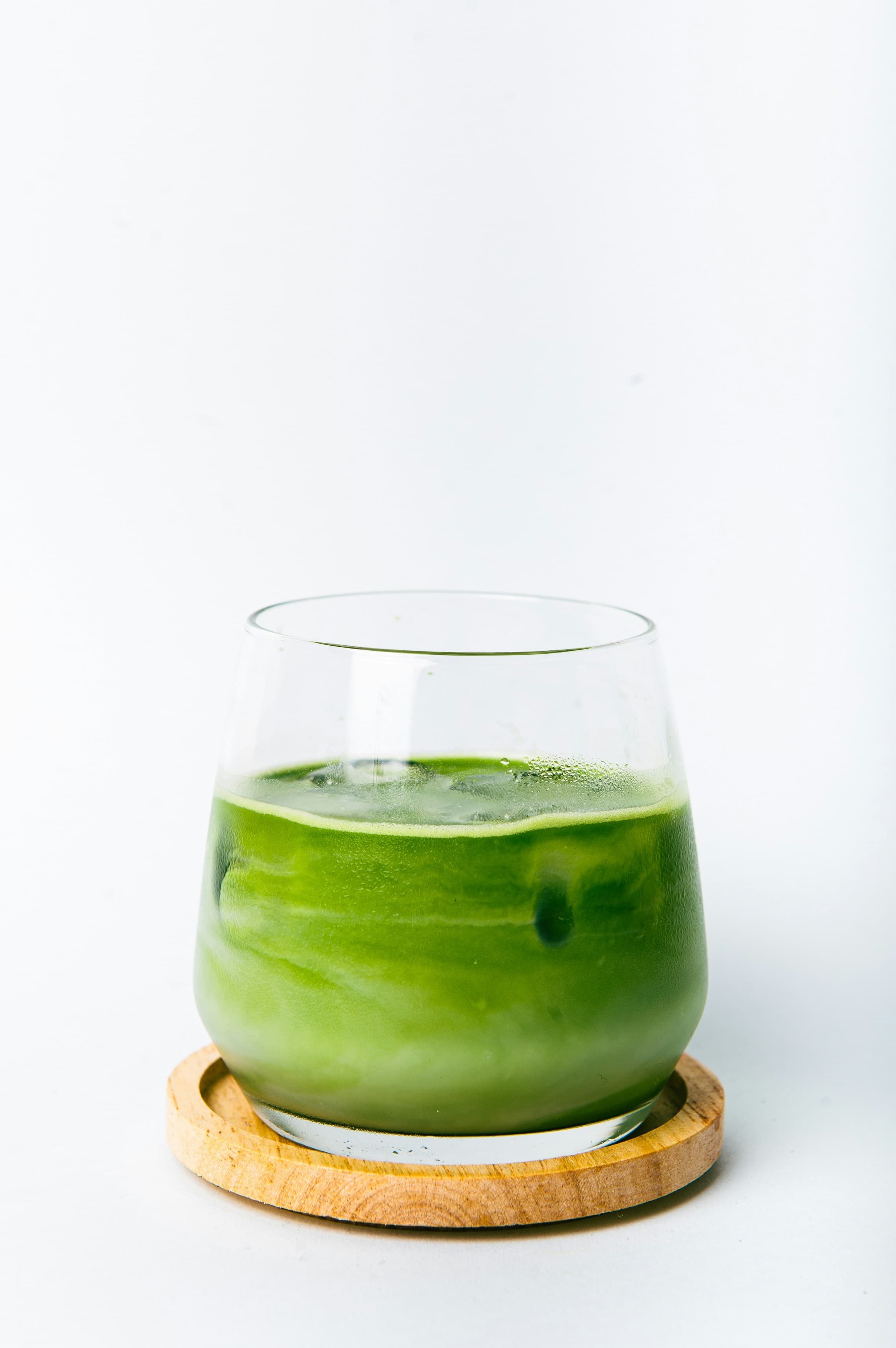 Iced matcha latte in glass with side view